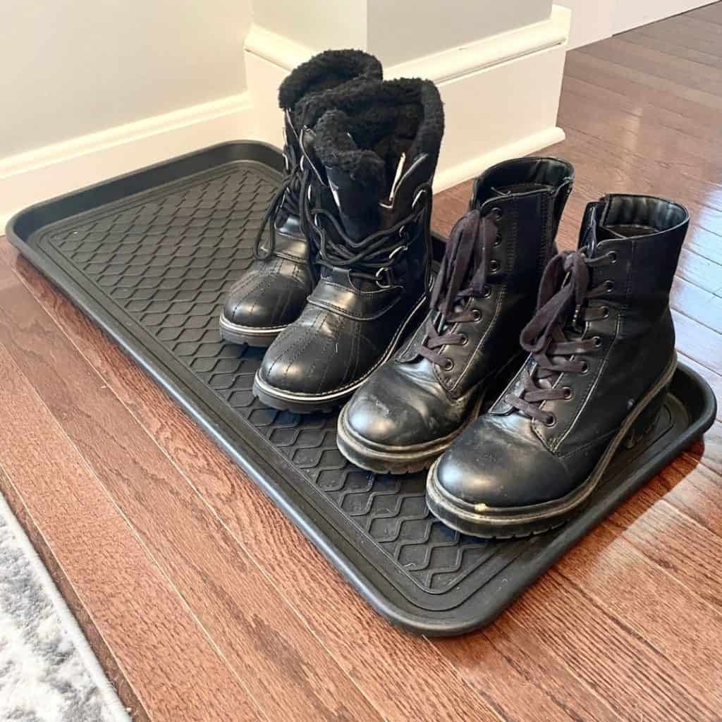 turning closet into mudroom with boots on a black boot tray