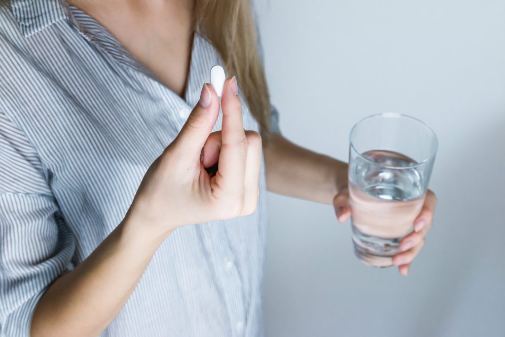 Mom taking medicine to get through a sick day with kids at home. #sickday #mom #selfcare