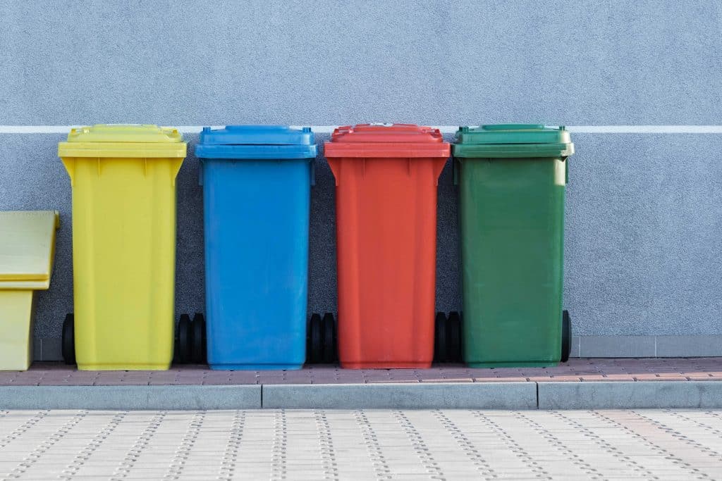 4 garbage  and recycle cans for clutter in colors yellow, blue, red, and green