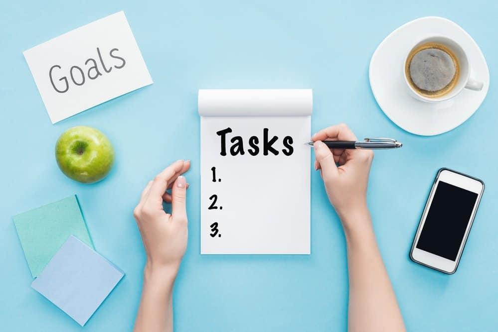 notepad for tasks numbered 1 through three on a blue background