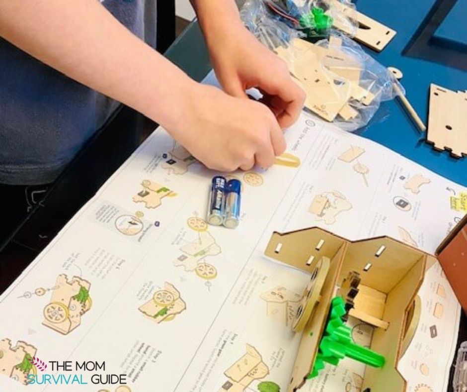 hands building something from best science kit