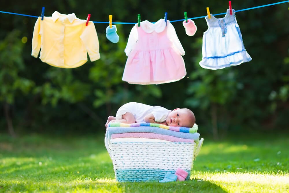 line dry clothes to stop static electricity baby clothes on a line and baby in a basket