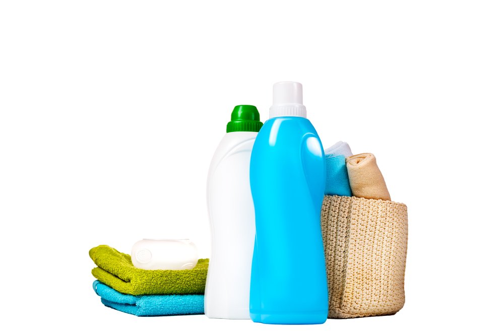 fabric softener substitutes in blue bottle and white bottle next to folded towels and basket