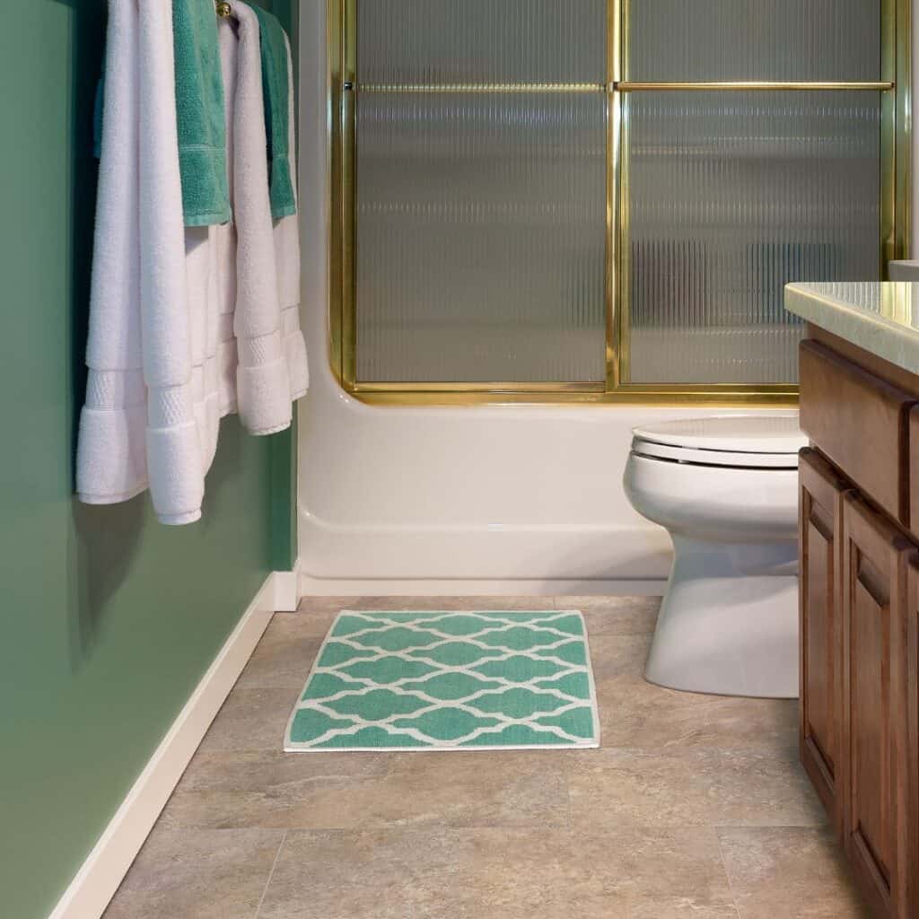 teal diamond bath mat in front of toilet